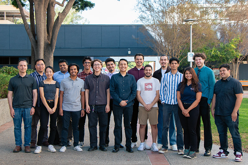 Team members stand in a group