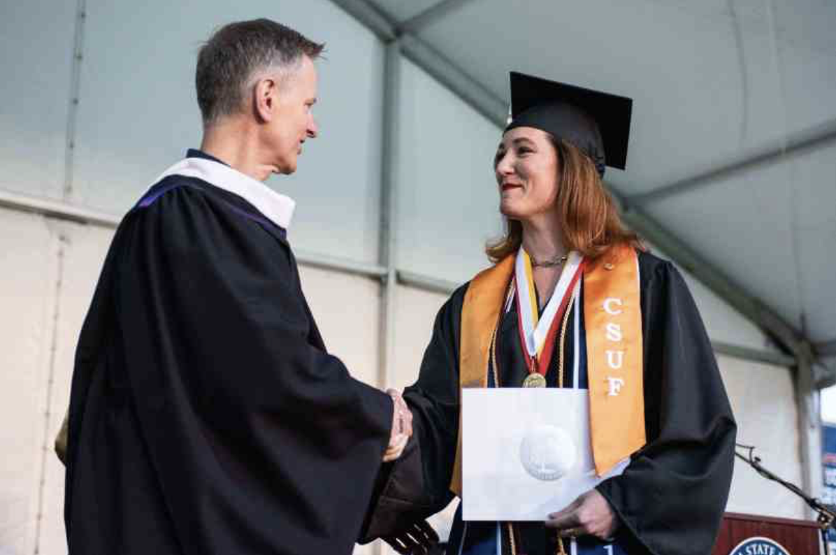 Dean Dale Merrill congratulates a graduating student