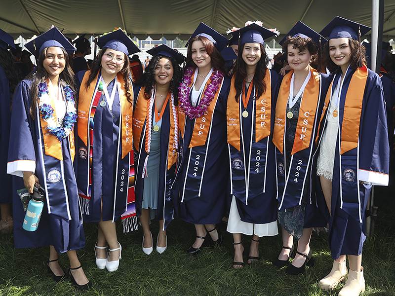 A group of women in commencement regalia.