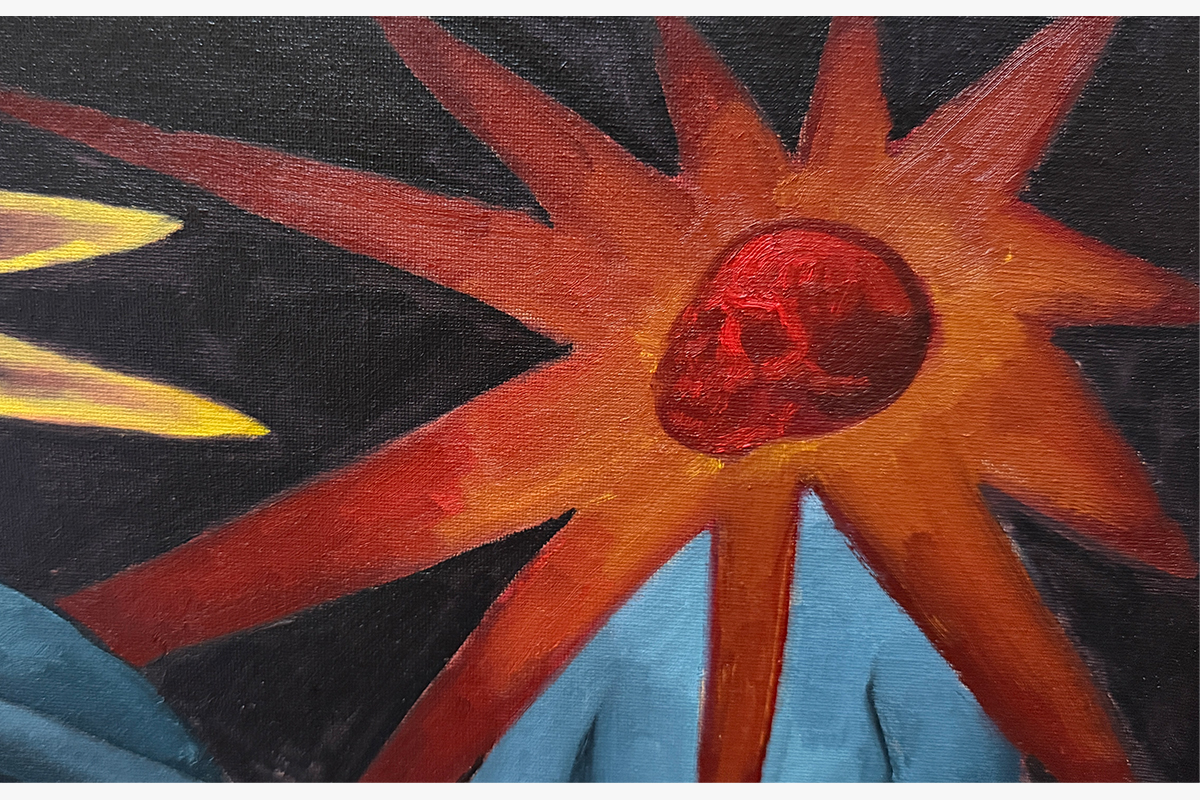 Red skulled figure with sunburst around the neck.