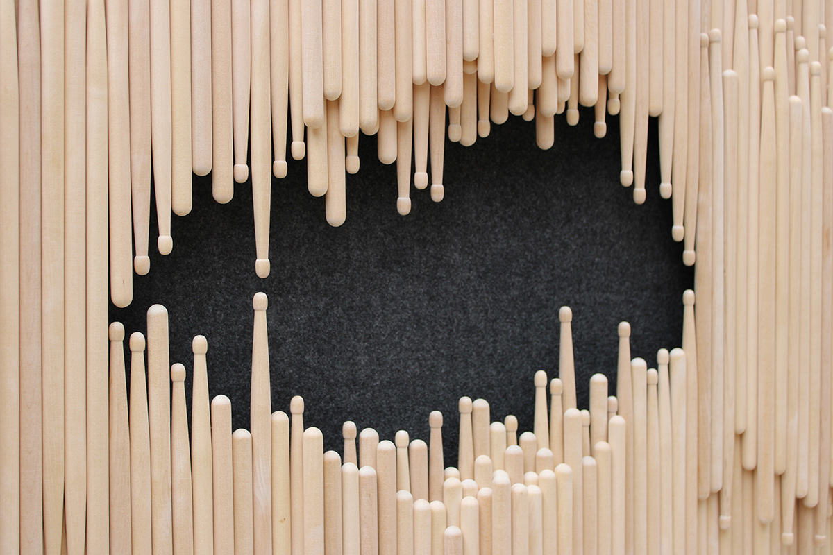 Closeup of drum sticks with a black void.