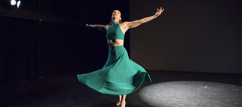 Woman dancing with arms outstretched