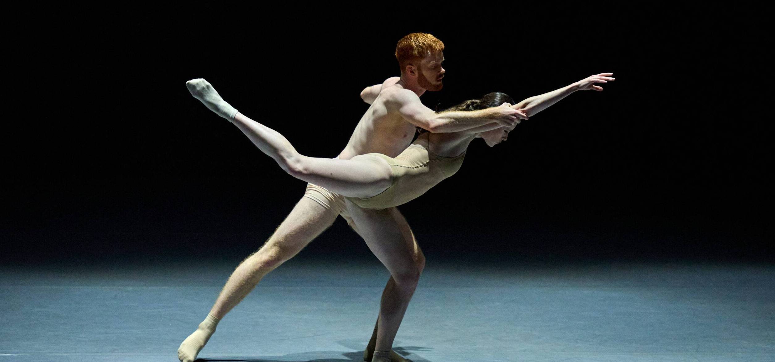 Spencer Everett supporting Jessie Yero on stage as she extends her leg back into attitude