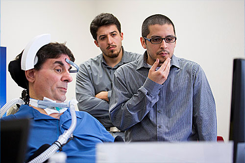 Students evaluating prototype headset with ALS patient