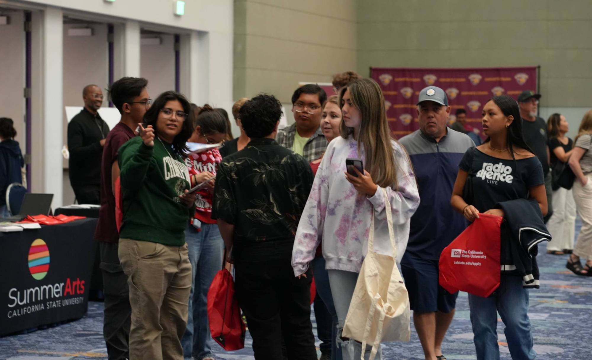 Students learn about college opportunities at a tabling event