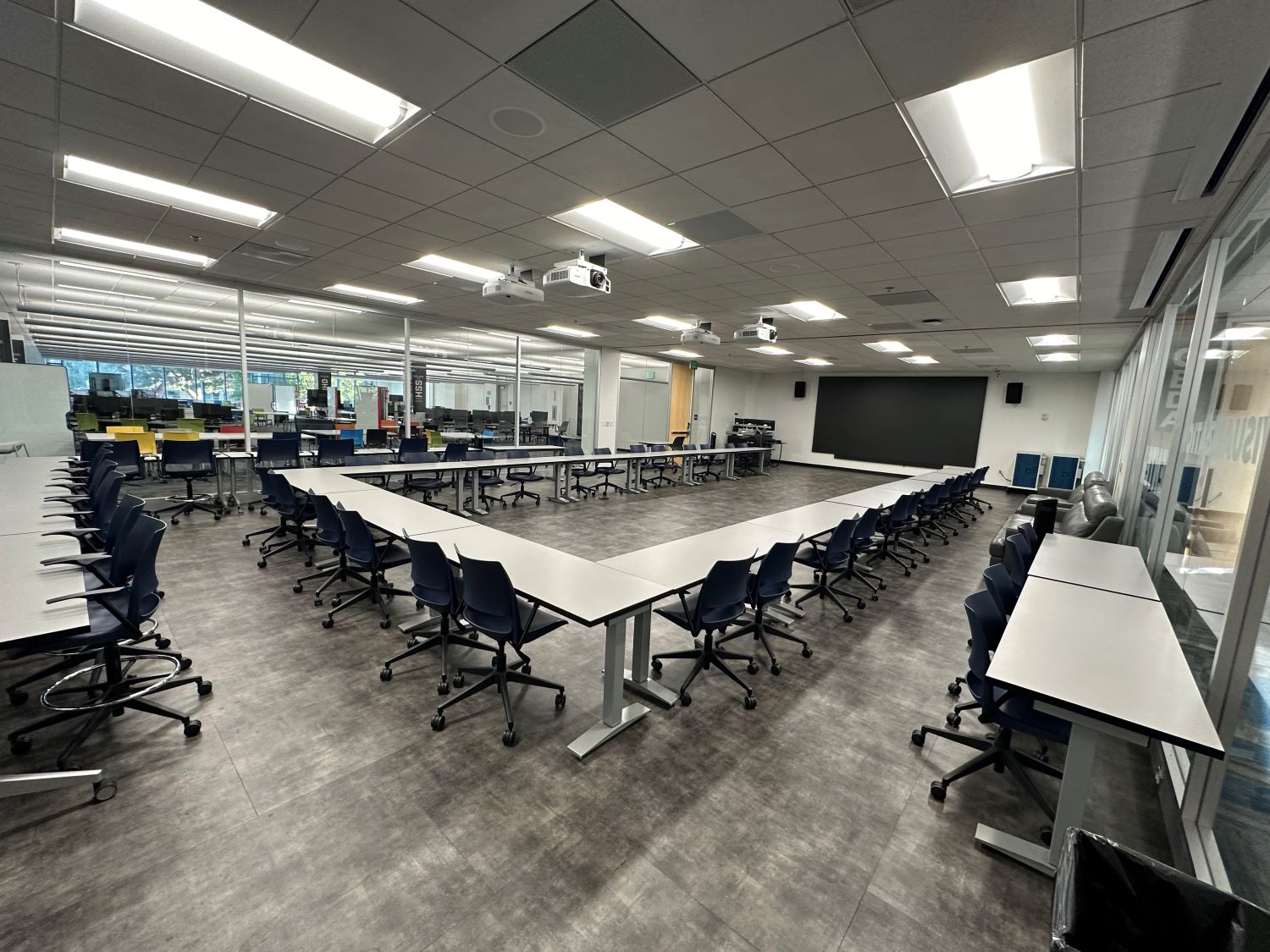 tables arranged in U-shape in center of room