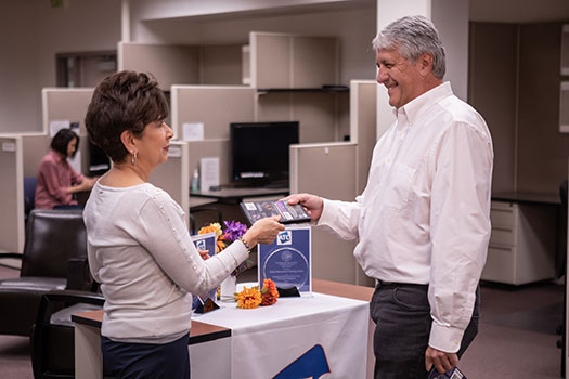 ATC staff explaining to a faculty member about what the ATC offers