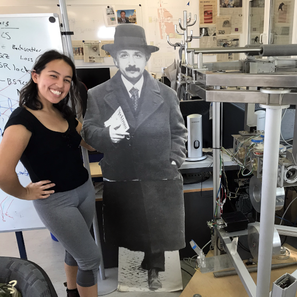 Denyz Melchor poses next to life size Einstein