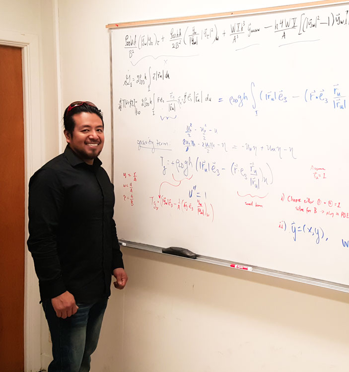Gabriel Martinez smiles while studying mathematics