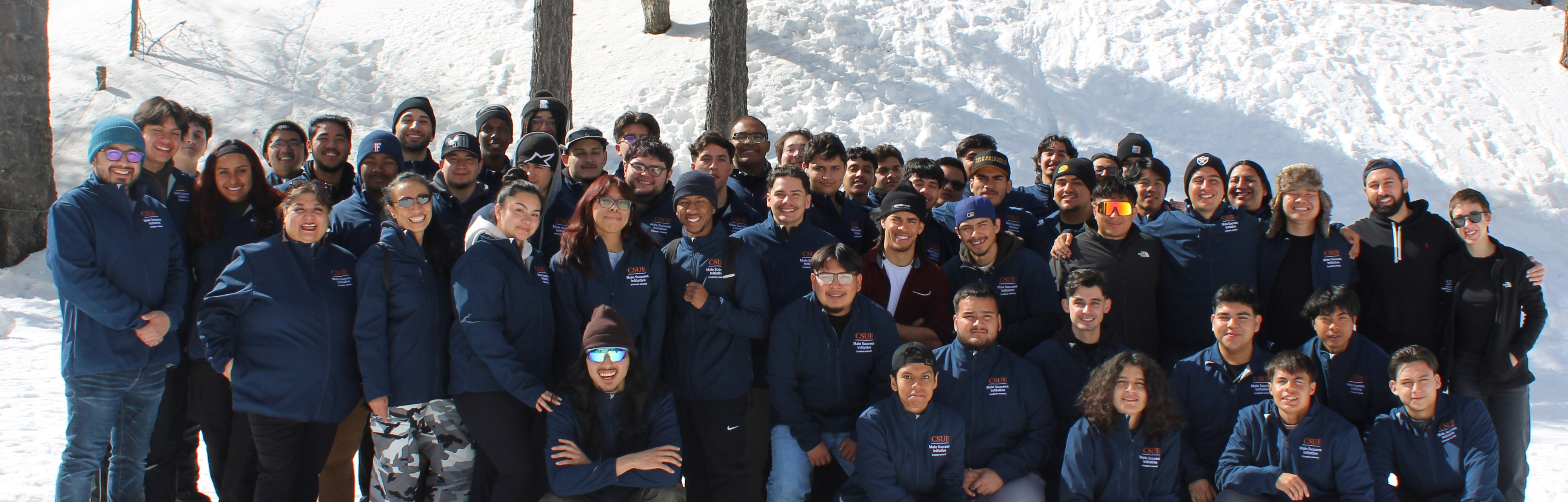 MSI staff and students posing in front of snow