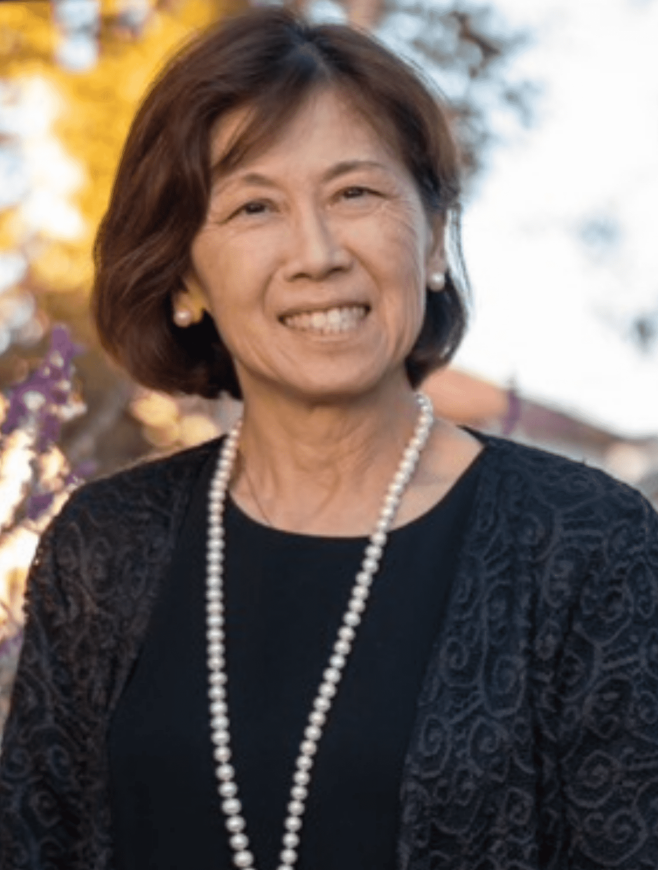 An Asian language instructor smiles for the camera.