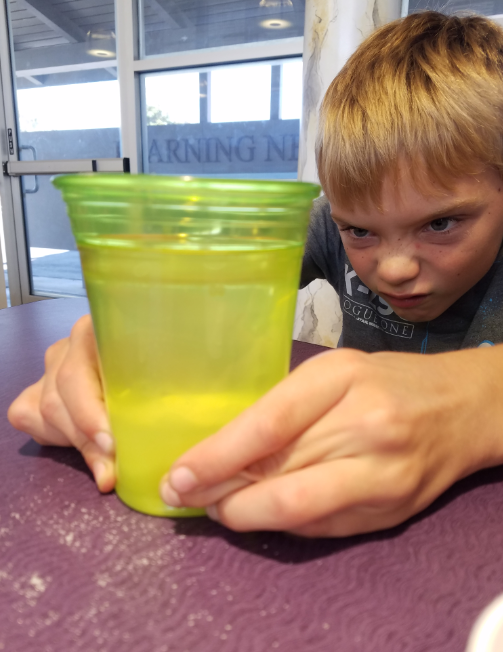 A Fern Drive student observing bubble formation in a "cauldron"