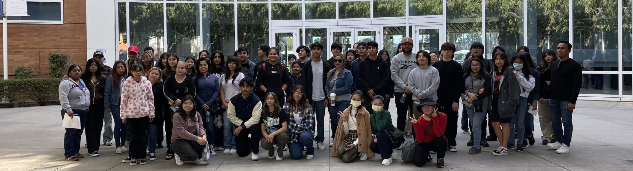 Group of students standing in front of college building