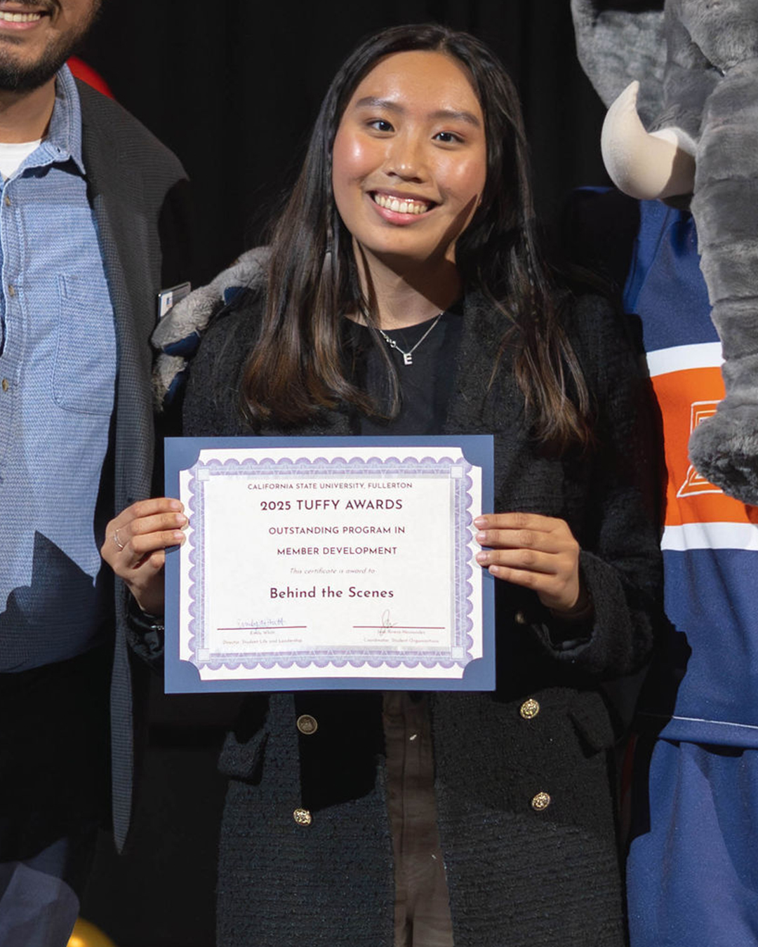 Student Holding Award for Outstanding Program in Student Development