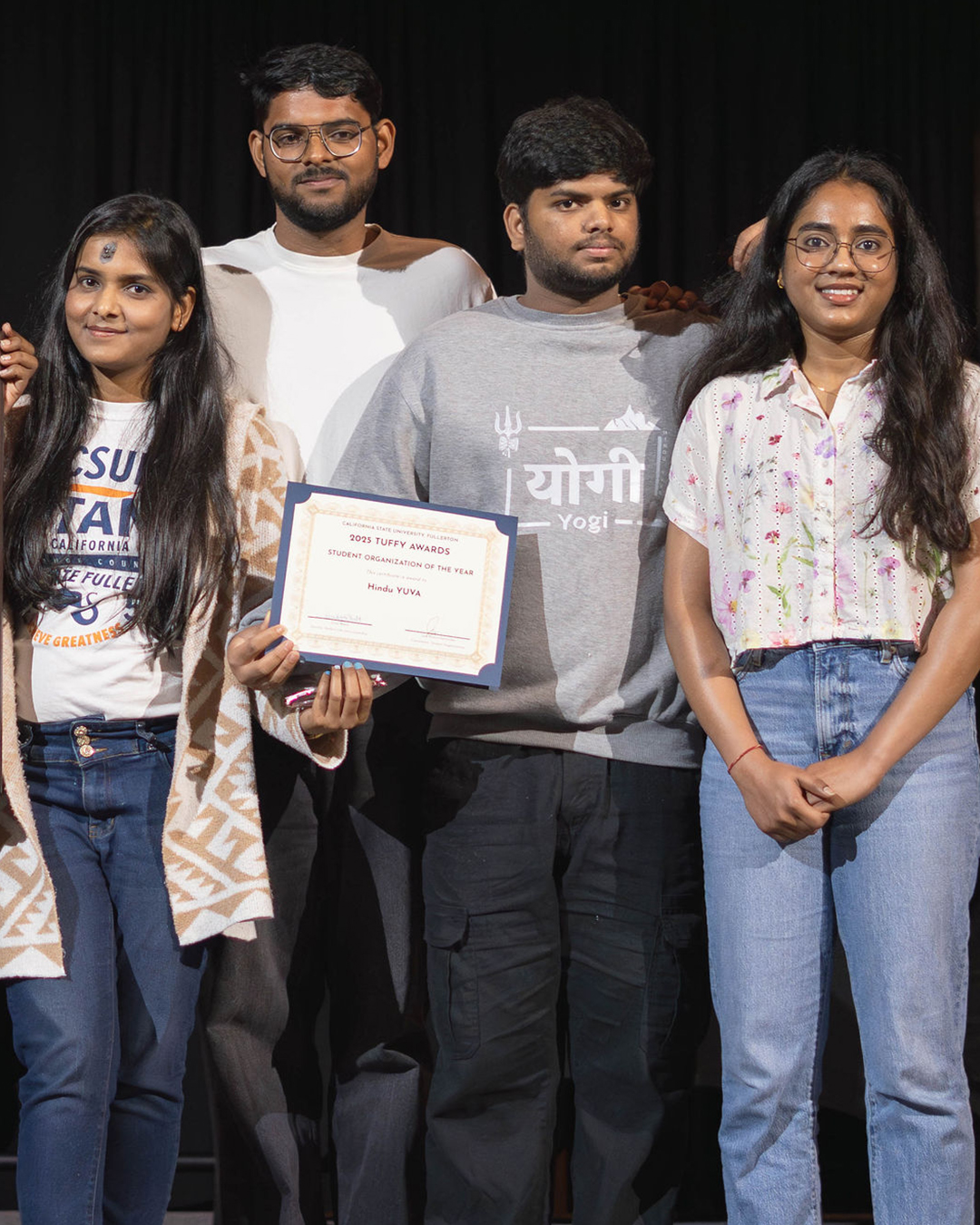 A group of students holding the award for Student Organization of the Year
