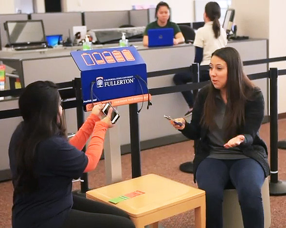 Students using smartphone charging station.