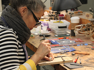 Jewelry student crafting a ring.