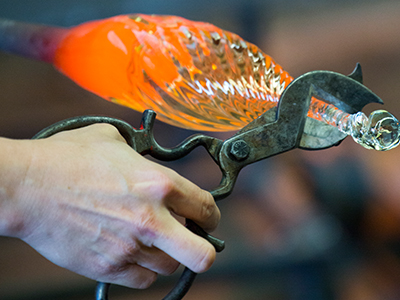 Glass vessel being cut after firing.
