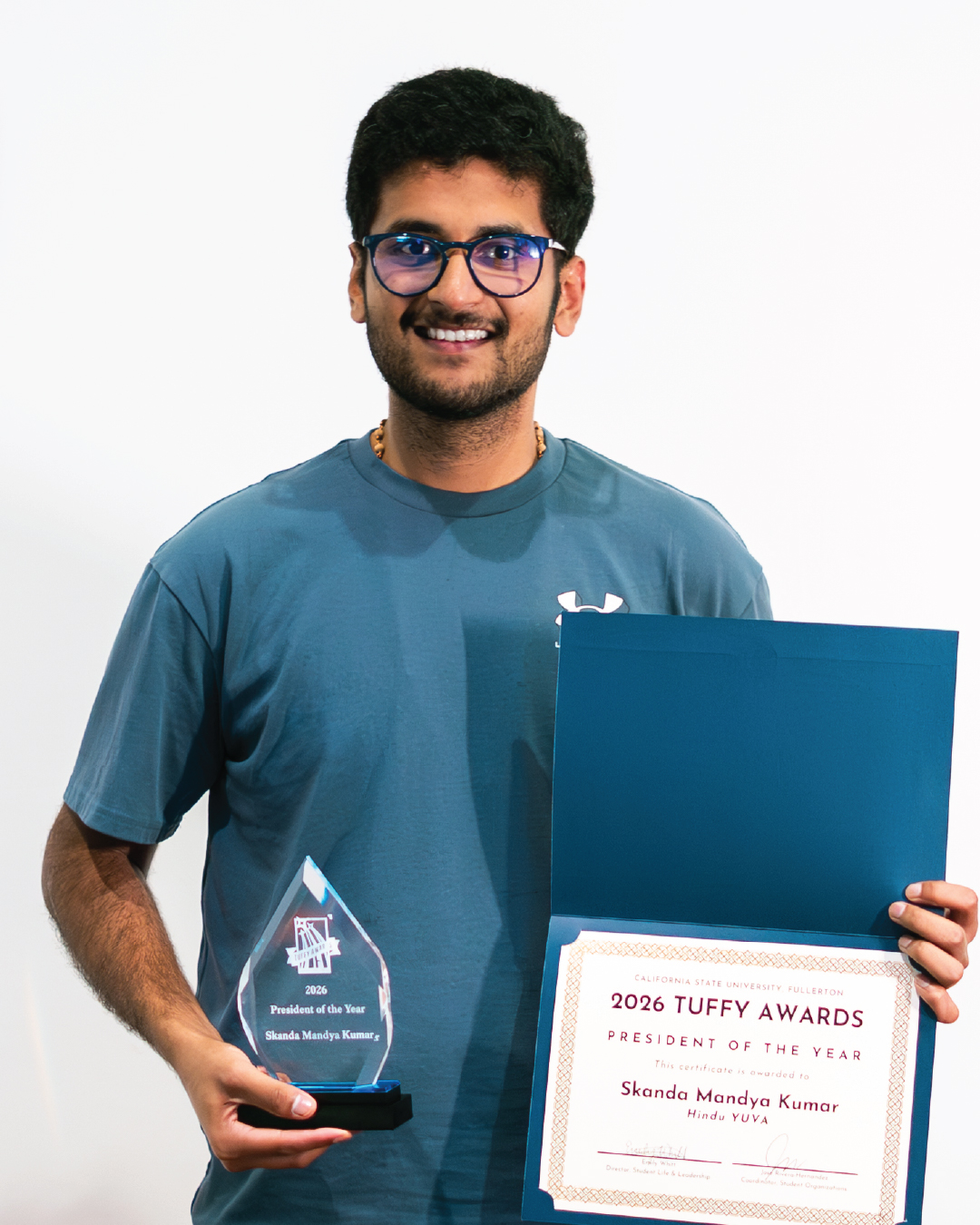 Student holding the award for President of the Year