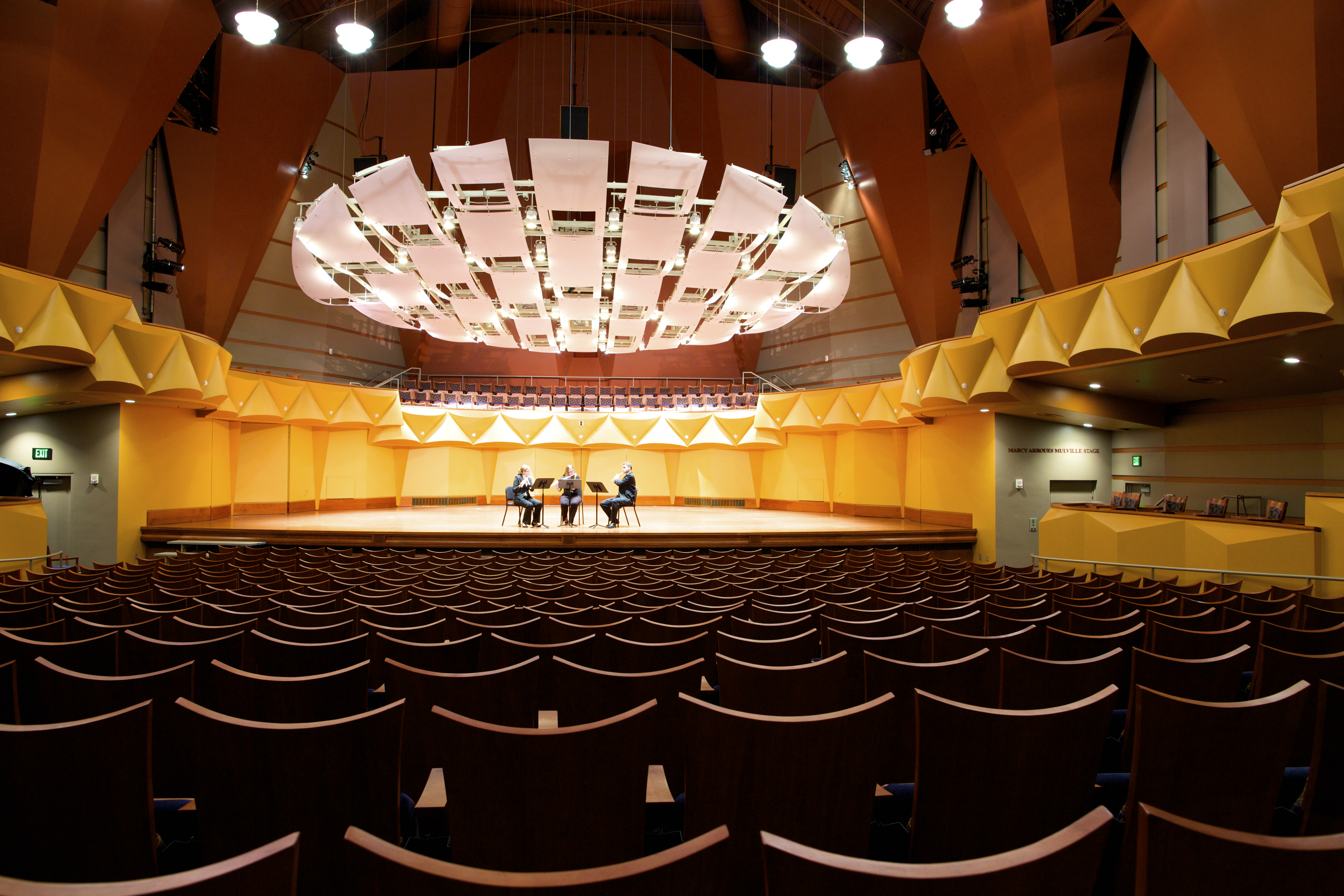 Musicians on stage in a concert hall.