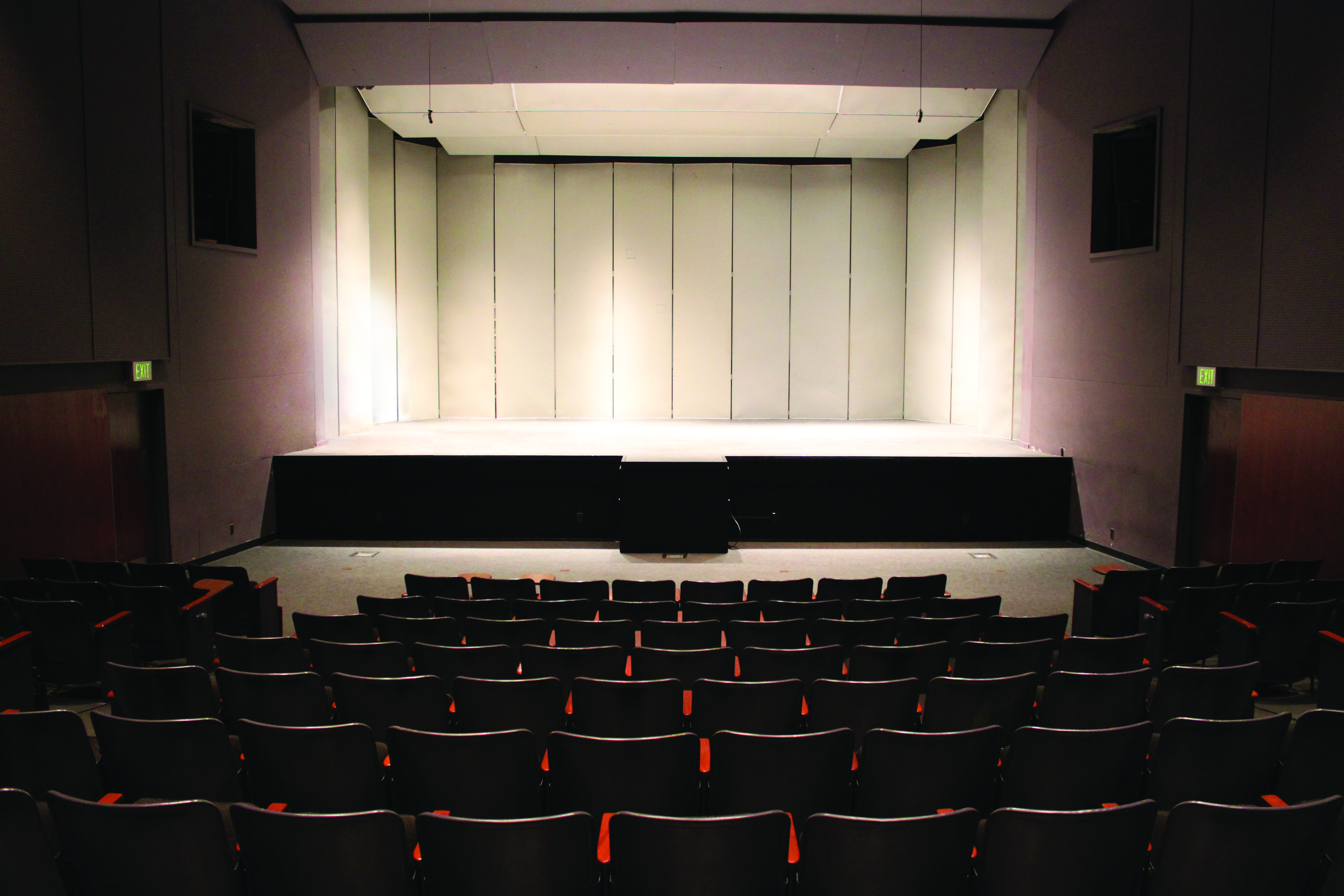 Seats and stage in a concert space.