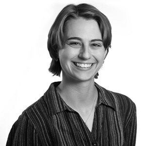 Smiling woman in front of patterned fabric