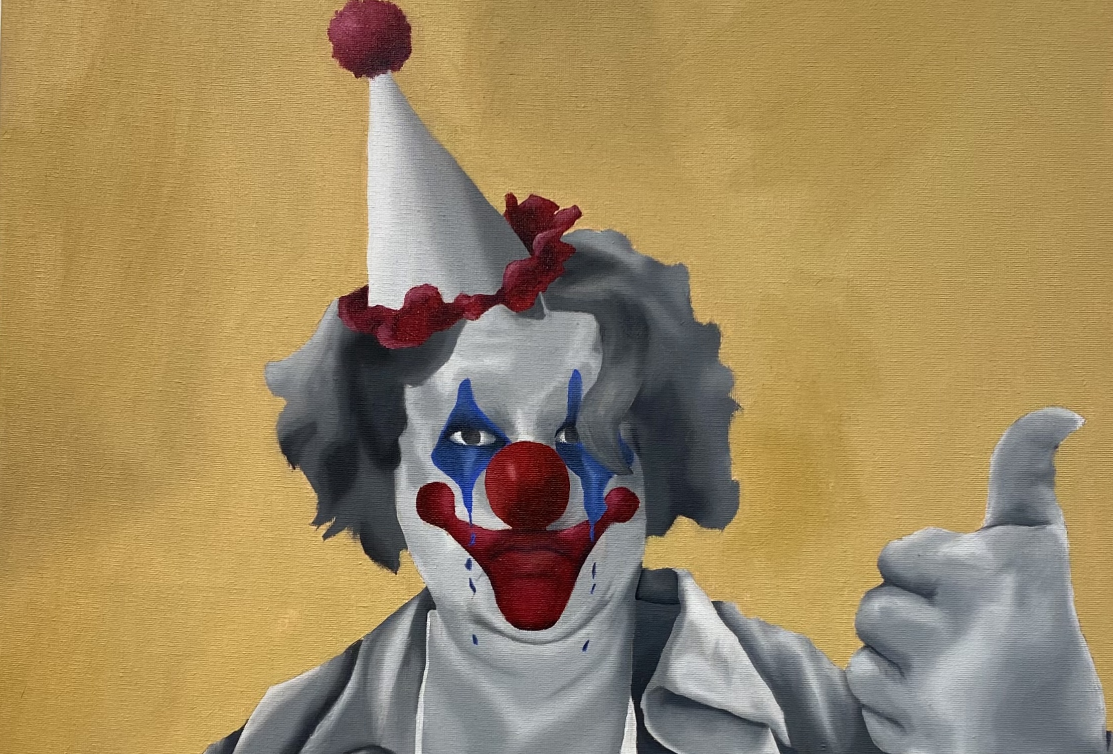 Clown figure with thumb up.