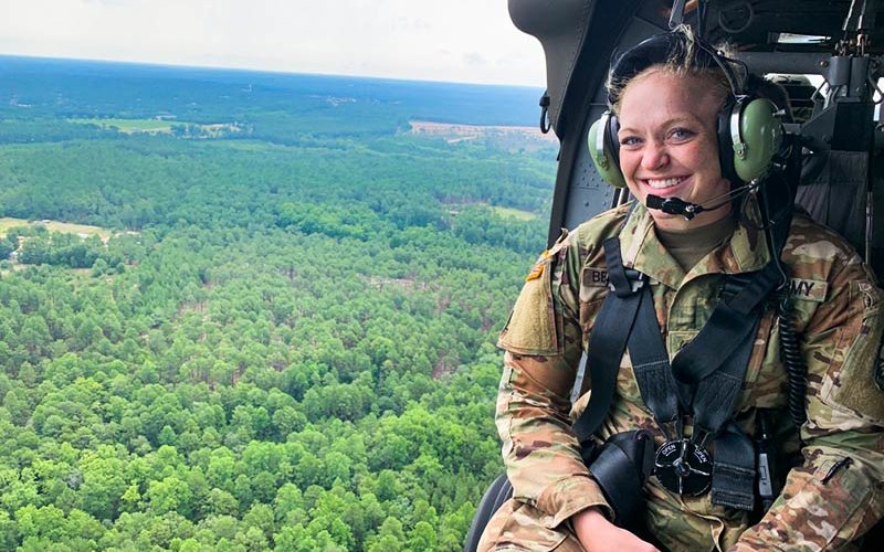 Woman riding in helicopter.