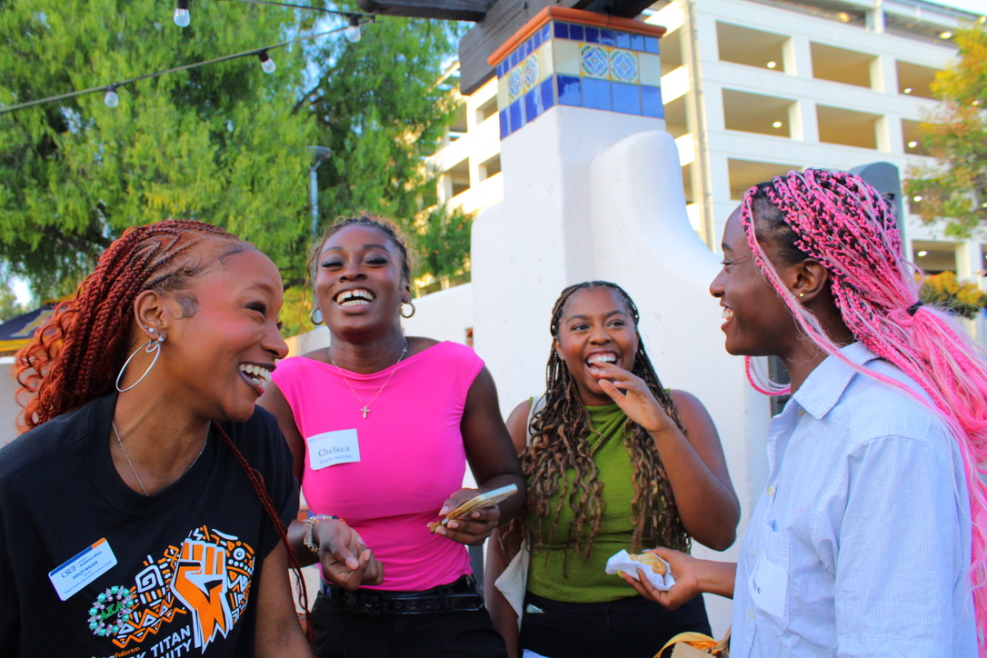 Four women laughing and enjoying each others company.