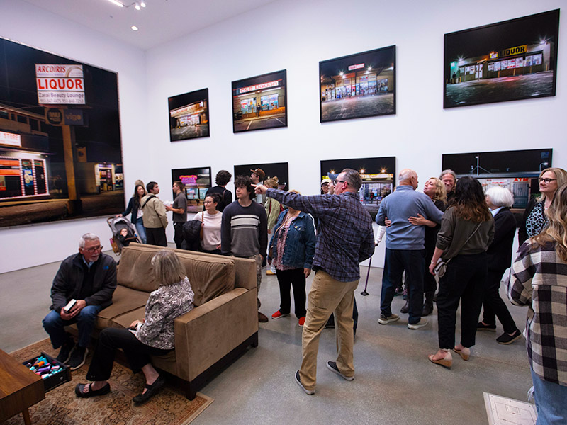 Crowd of visitors congregating in exhibition opening