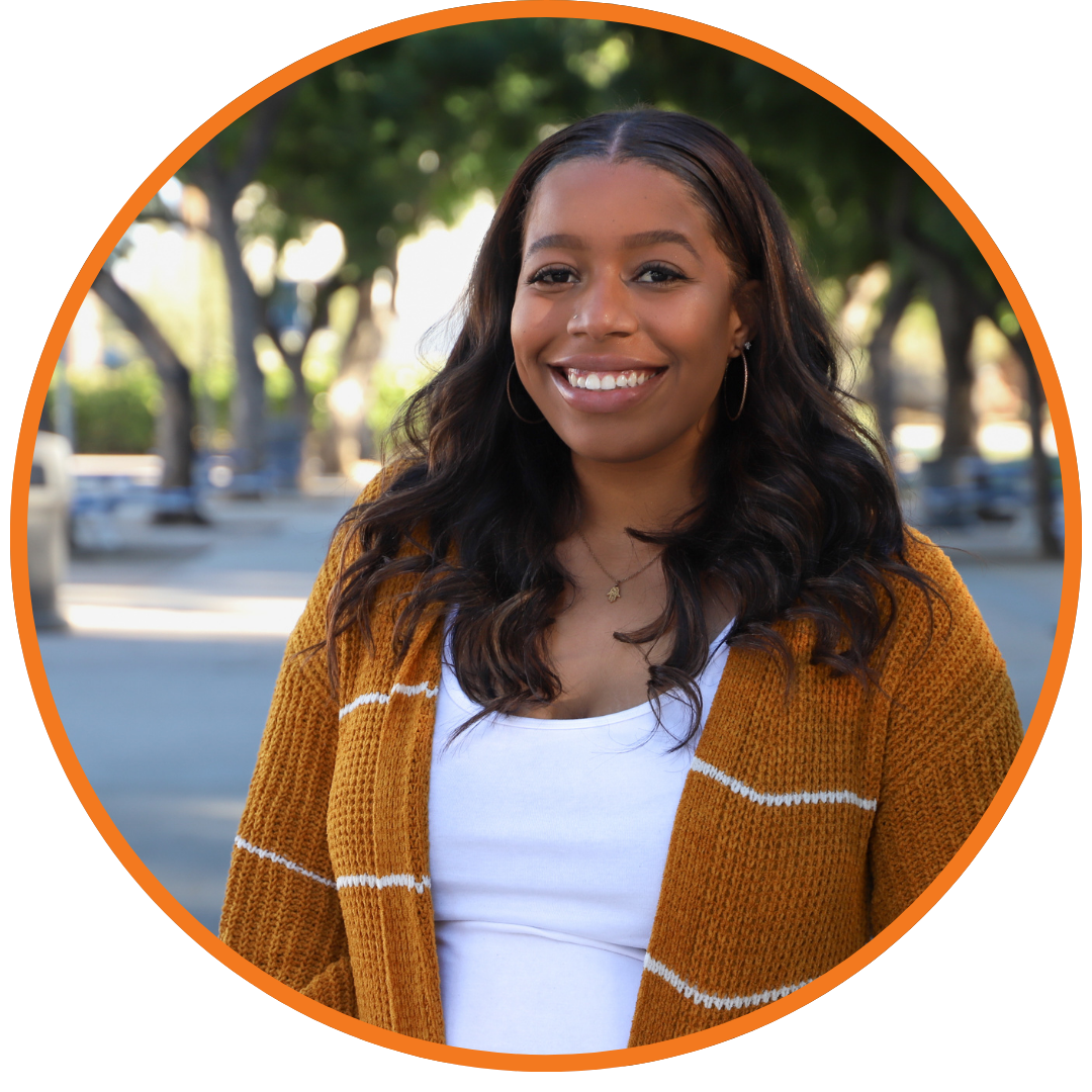 person smiling with brown sweater