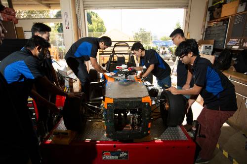 mechanical engineering student working on their vehicle project.