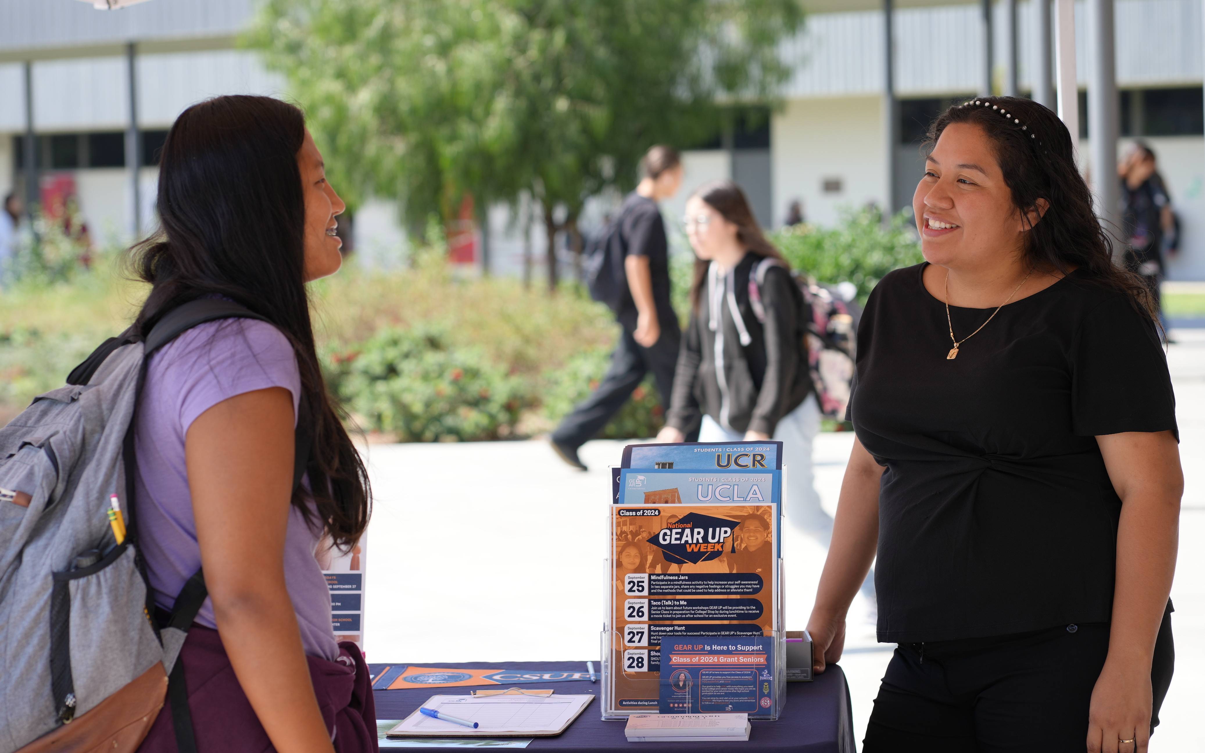 GEAR UP staff speaking with GEAR UP student