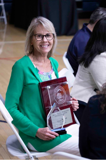 Lynn receiving the Titan Excellence Award in 2023.
