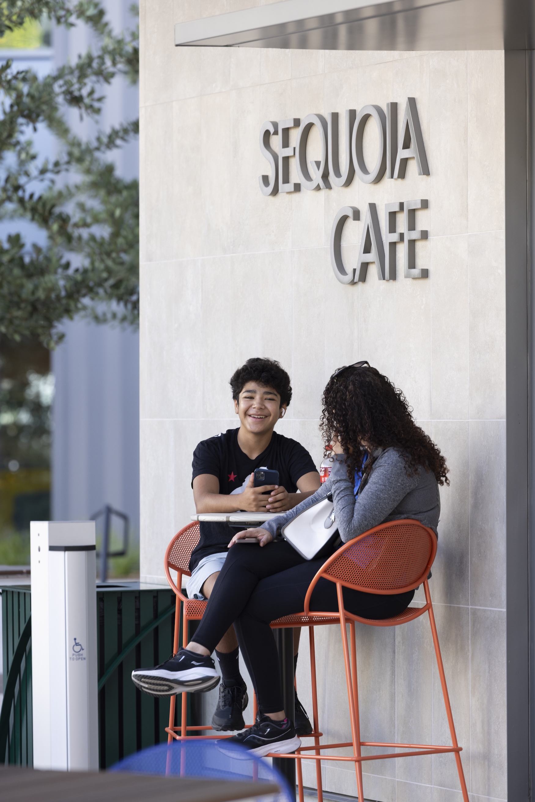 Two persons sitting outside Sequoia Cafe