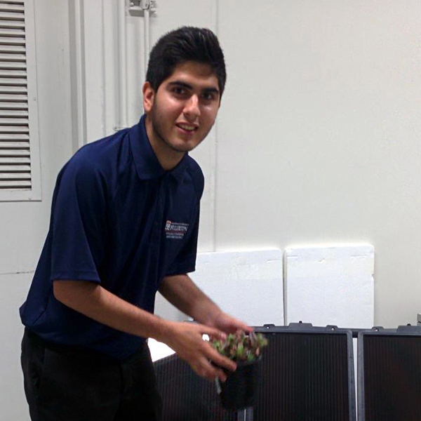 Adrian Guzman Adrian Guzman holding a component for solar panels