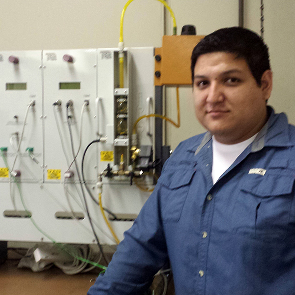 Adrian Iniguez Adrian Iniguez posing next to a mechanism for diesel engines