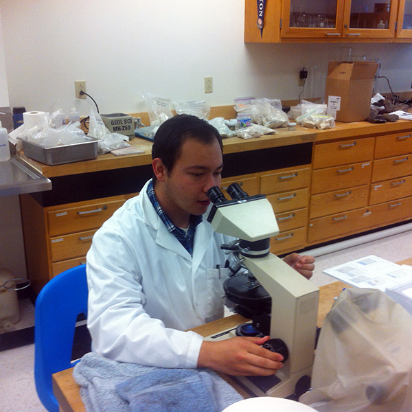 Adam Ramirez Adam Ramirez looking through the microscope
