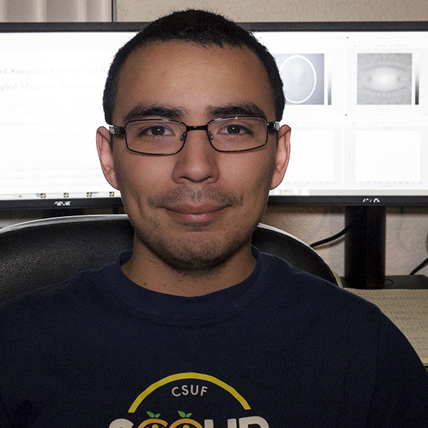 Rudolph Saenz Rudolph Saenz posing infront of two computer monitors