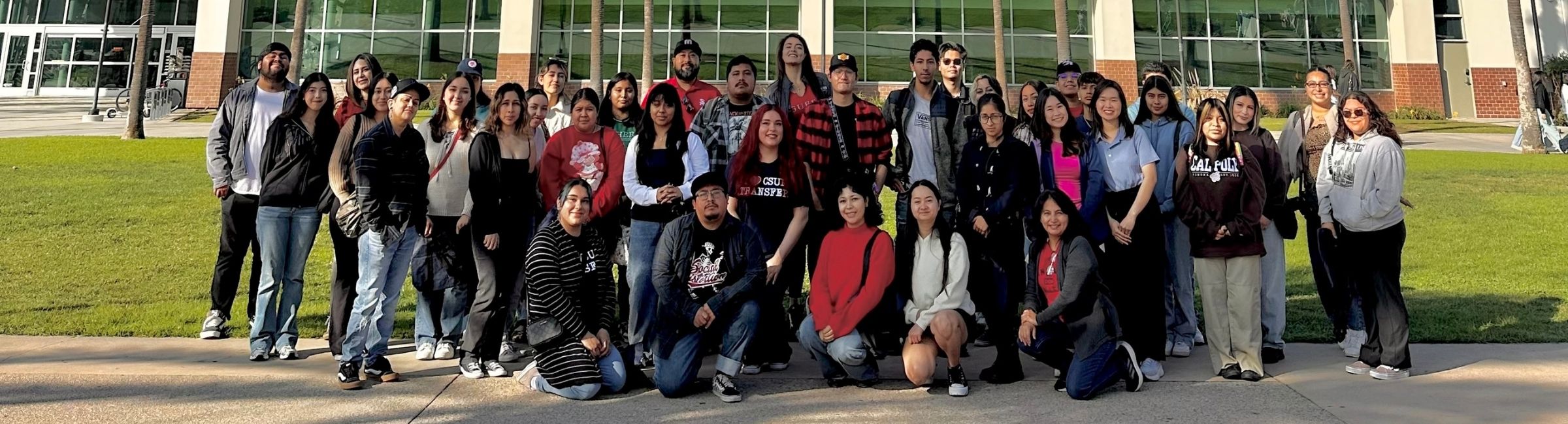 Group of transfer students standing outdoors in front of the Student Recreation Center at Cal State Fullerton.