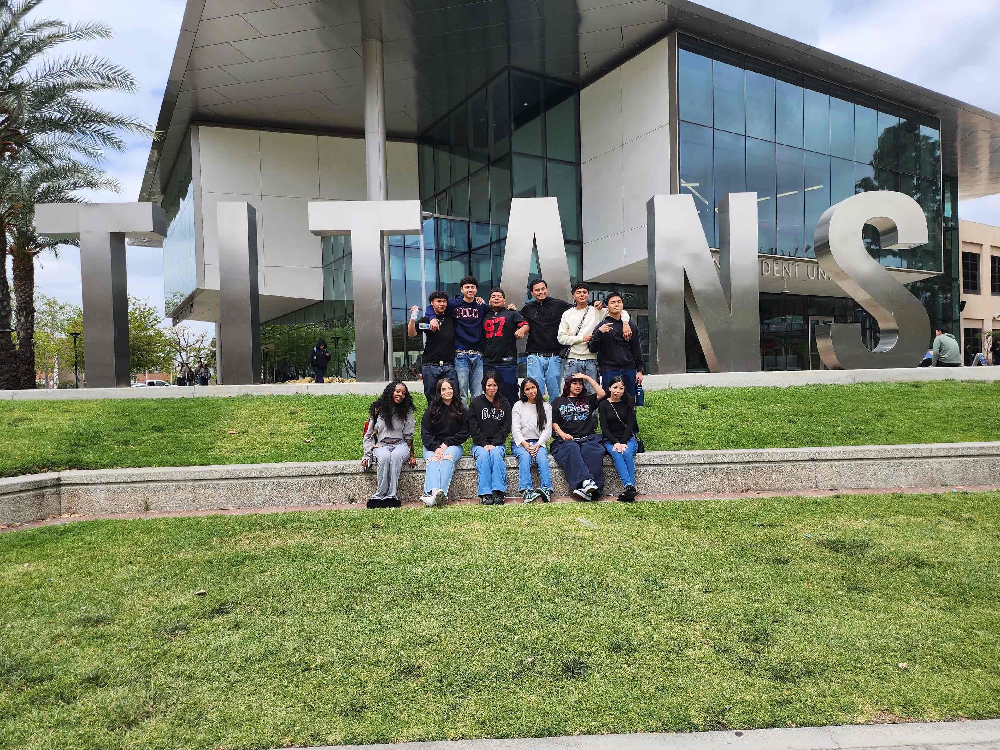 Dare to Dream Conference attendees gathered at the CSUF TITANS sign