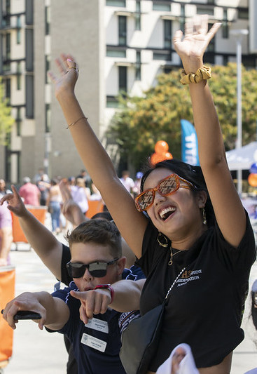 Resident Student Association members cheer for incoming students as they move in on residential Move In Day