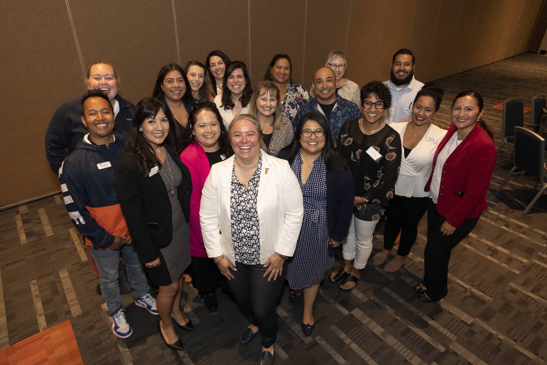 Cal State Fullerton staff alongside Santa Ana College staff pose for a picture during in an event celebration of a partnership contract between the two schools. 