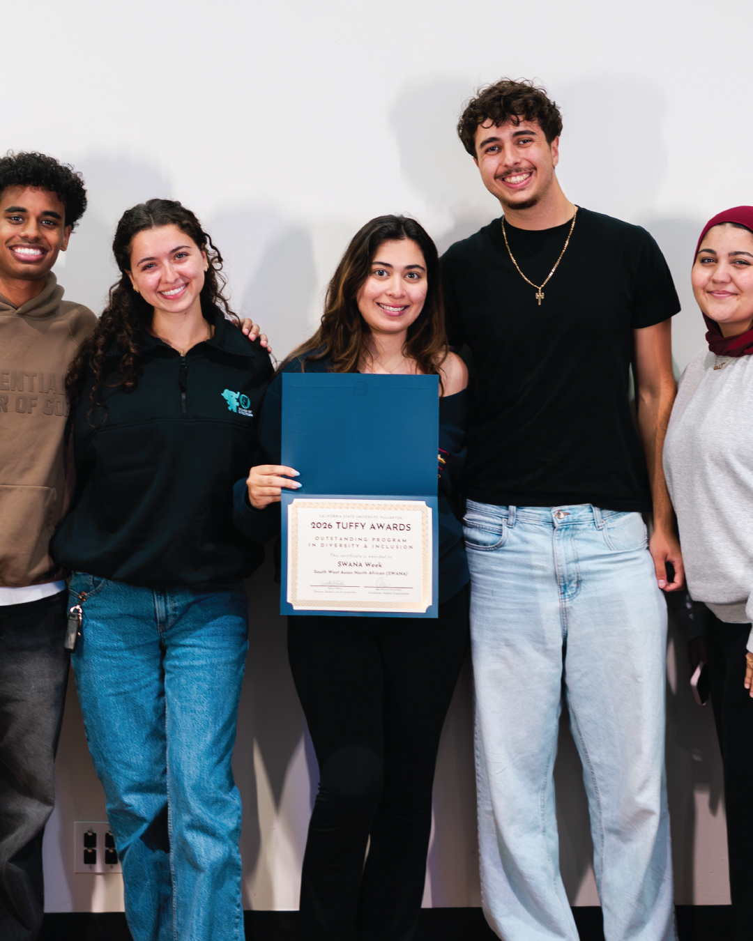 Students holding an award for Outstanding Program in Diversity & Inclusion