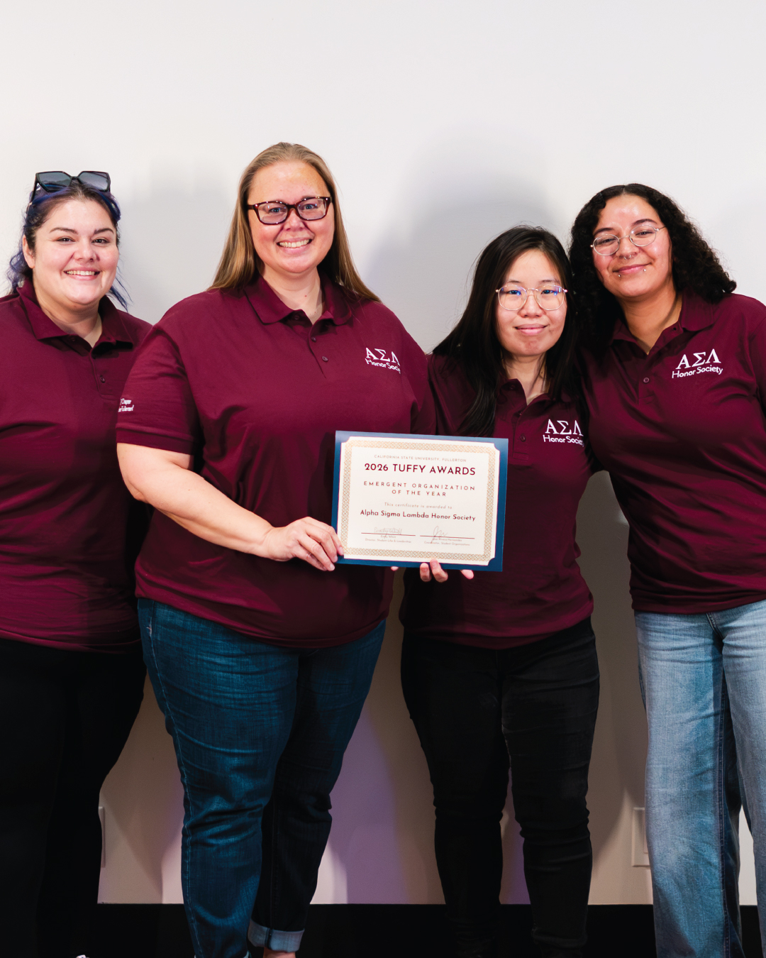 Students holding an award for Emergent Organization of the Year