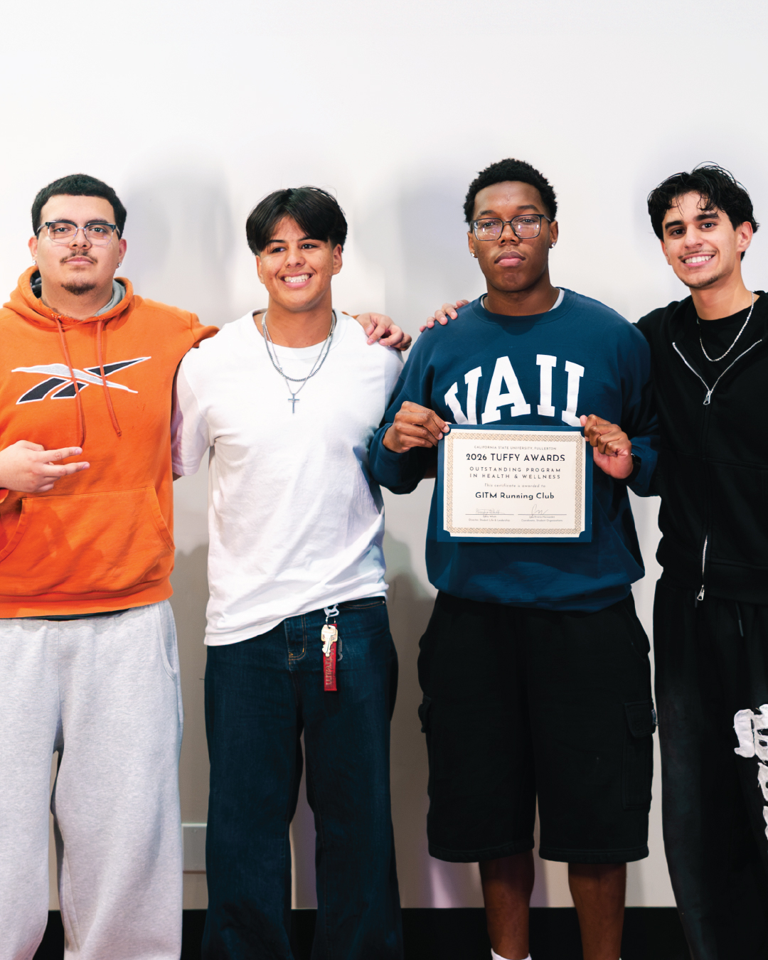 Student holding an award for Outstanding Program in Health and Wellness