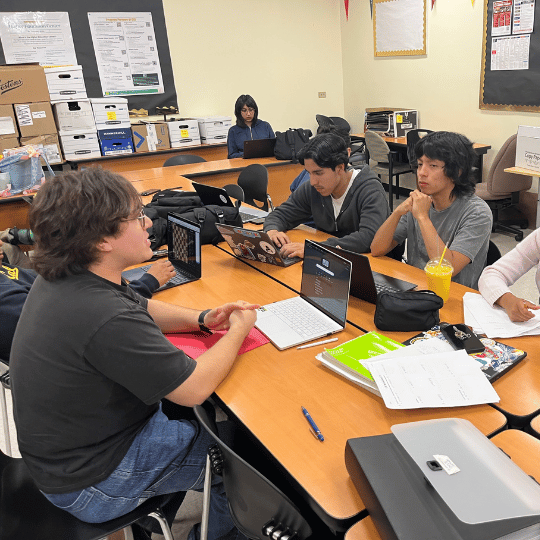 A tutor helping students with their assignments.