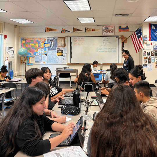 Students receiving tutoring support in a classroom.